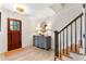 Warm foyer with wood flooring, staircase and stylish wood and blue dresser at 5705 Odell St, Cumming, GA 30040