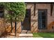 Inviting entryway featuring a brick facade, manicured lawn and an arched front door at 5705 Odell St, Cumming, GA 30040