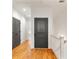 Bright hallway with gleaming hardwood floors, black doors, and white trim at 5705 Odell St, Cumming, GA 30040