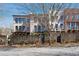 A row of stately townhomes featuring a brick wall surrounding the property at 5705 Odell St, Cumming, GA 30040