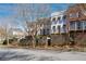 A row of upscale townhomes are protected by a brick perimeter wall and lush landscaping at 5705 Odell St, Cumming, GA 30040