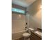 Bathroom featuring a shower-tub combo, granite countertop, and new toilet at 8141 Hickory Dr, Covington, GA 30014