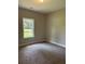 Bedroom with neutral walls, carpeted floors and a large window for natural light at 8141 Hickory Dr, Covington, GA 30014