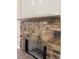 Close up of the detailed stone fireplace with a hearth and raw wood mantle at 8141 Hickory Dr, Covington, GA 30014