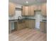 Spacious kitchen featuring granite counters, farm sink and stainless steel appliances at 8141 Hickory Dr, Covington, GA 30014