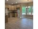 Eat-in kitchen features light-colored cabinets, granite countertops, a chandelier, and lots of natural light at 8141 Hickory Dr, Covington, GA 30014