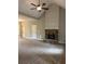 Open living room features a vaulted ceiling, wood-look floors, stone fireplace, and neutral paint scheme at 8141 Hickory Dr, Covington, GA 30014