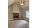Cozy living room featuring a stone fireplace, ceiling fan, neutral walls and hardwood floors at 8141 Hickory Dr, Covington, GA 30014