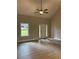 Bright living room offers wood-look floors, a vaulted ceiling, neutral paint, and natural light from the front door at 8141 Hickory Dr, Covington, GA 30014
