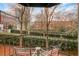 Balcony with outdoor seating overlooking landscaped green space and city views at 2840 Peachtree Nw Rd # 301, Atlanta, GA 30305