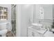 Elegant bathroom featuring a vessel sink, frameless glass shower, and modern lighting at 2840 Peachtree Nw Rd # 301, Atlanta, GA 30305