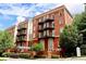 Stunning brick building featuring charming balconies and manicured landscaping, creating a welcoming atmosphere at 2840 Peachtree Nw Rd # 301, Atlanta, GA 30305