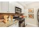 Kitchen featuring granite counters, stainless appliances, and tile backsplash at 2840 Peachtree Nw Rd # 301, Atlanta, GA 30305
