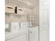 Bright laundry area with shelving, laundry supplies and modern, white washer and dryer at 2840 Peachtree Nw Rd # 301, Atlanta, GA 30305