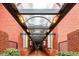 Inviting covered walkway with brick walls and a transparent arched ceiling leads to the building entrance at 2840 Peachtree Nw Rd # 301, Atlanta, GA 30305