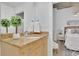 Well lit bathroom featuring a granite-topped vanity and an elegant round mirror at 3324 Peachtree Ne Rd # 2903, Atlanta, GA 30326