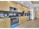 Modern kitchen featuring sleek stainless steel appliances and blonde wood cabinets at 3324 Peachtree Ne Rd # 2903, Atlanta, GA 30326