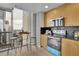 Modern kitchen features stainless steel appliances, black backsplash, and breakfast bar with city views at 3324 Peachtree Ne Rd # 2903, Atlanta, GA 30326