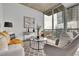 Bright living room with floor-to-ceiling windows, stylish furniture, and stunning city views at 3324 Peachtree Ne Rd # 2903, Atlanta, GA 30326