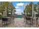 Outdoor patio with seating and tables, surrounded by lush greenery at 3324 Peachtree Ne Rd # 2903, Atlanta, GA 30326