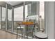 Balcony table and chairs overlook city views and the balcony's large windows at 3324 Peachtree Ne Rd # 2903, Atlanta, GA 30326