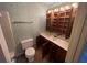 Bathroom featuring a combination of open shelves, vanity, toilet, and tub shower combo at 3998 Elm St, Atlanta, GA 30341