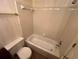 Full bathroom with a tile-surround bathtub and toilet at 3998 Elm St, Atlanta, GA 30341