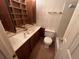 Bathroom featuring vanity with built-in shelves, toilet, and shower at 3998 Elm St, Atlanta, GA 30341