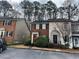 Charming townhouse featuring a brick facade, red door, and front yard landscaping at 3998 Elm St, Atlanta, GA 30341