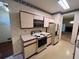 Well-lit kitchen featuring white cabinets, laminate countertops, and classic appliances at 3998 Elm St, Atlanta, GA 30341