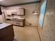Bright kitchen with white cabinets, tile floors, and vintage wallpaper at 3998 Elm St, Atlanta, GA 30341