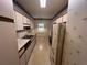 Bright kitchen featuring white cabinets, laminate countertops, and vintage wallpaper at 3998 Elm St, Atlanta, GA 30341