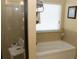 Bathroom with separate tub and shower and a window at 40 Adler Pl, Covington, GA 30016