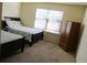 Bedroom with two twin beds, wardrobe closet, and a window that provides natural light at 40 Adler Pl, Covington, GA 30016