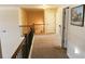 Open hallway featuring neutral carpet, with stairs to the left and doorway leading to the bedrooms at 40 Adler Pl, Covington, GA 30016