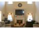 Bright living room with fireplace and mantle below wall-mounted TV at 40 Adler Pl, Covington, GA 30016