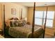 Main bedroom featuring a four-poster bed with decorative pillows and a window offering natural light at 40 Adler Pl, Covington, GA 30016