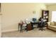 Office area with neutral carpet, tan walls, desk, and computer setup at 40 Adler Pl, Covington, GA 30016