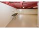 Unfinished basement featuring exposed red ceiling rafters and a concrete floor at 4995 Greentree Trl, College Park, GA 30349