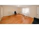 Bedroom showcasing light hardwood floors, desk and chair, and natural light from a large window at 4995 Greentree Trl, College Park, GA 30349