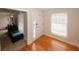 Bright entryway featuring hardwood floors, a white front door, and a large window for natural light at 4995 Greentree Trl, College Park, GA 30349