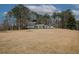 Wide angle of a gray two-story home on a large lot, surrounded by mature trees and landscaping at 4995 Greentree Trl, College Park, GA 30349