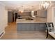 Spacious open kitchen with gray cabinetry, granite countertops, modern lighting, and stainless steel appliances at 4995 Greentree Trl, College Park, GA 30349
