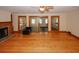 Bright living room featuring wood floors, wood burning fireplace, ceiling fan, and outdoor access at 4995 Greentree Trl, College Park, GA 30349