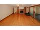 Open living room featuring hardwood floors, wood burning fireplace, ceiling fan, and outdoor access at 4995 Greentree Trl, College Park, GA 30349