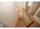 Carpeted staircase with white railing leading to the lower level with hardwood floors at 4995 Greentree Trl, College Park, GA 30349