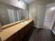 Bathroom vanity with long countertop, dark wood floors, and bright lighting at 5872 Fox Run, Rex, GA 30273