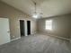 Neutral bedroom featuring soft carpeting, a ceiling fan, and natural light from the window at 5872 Fox Run, Rex, GA 30273