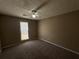 Cozy bedroom with carpeted floors, a ceiling fan, and a bright window at 5872 Fox Run, Rex, GA 30273