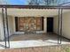 The covered front porch features unique stone accents, and decorative ironwork at 5872 Fox Run, Rex, GA 30273